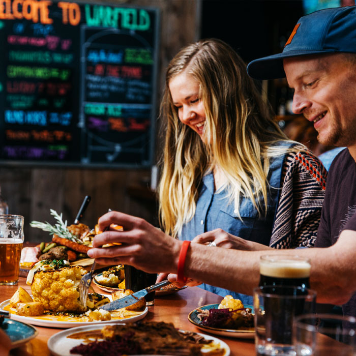 image3 man and woman cutting up food and smiling